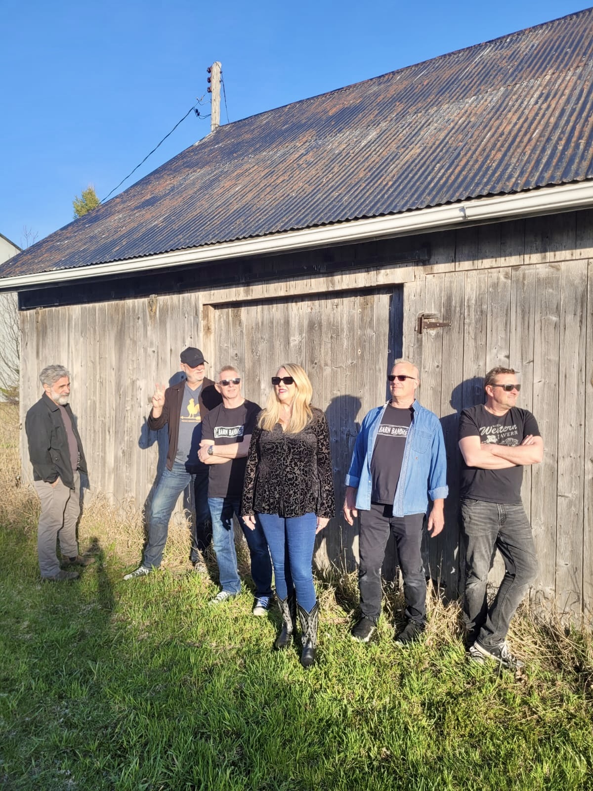 BARN BANDits leaning against a County barn